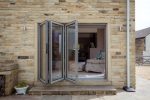 Aluminium bifold doors featuring satin glass, custom-made by Quickslide