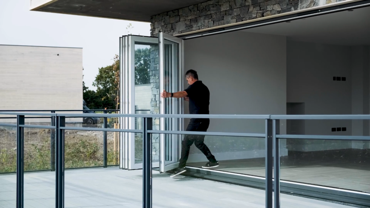 Slide and stack door system featuring aluminium panels for versatile home entrances.