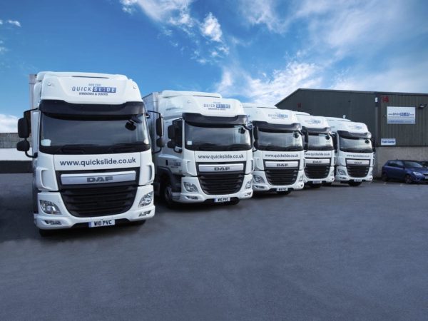 Quickslide delivery trucks lined up and ready for dispatch, ensuring timely window deliveries